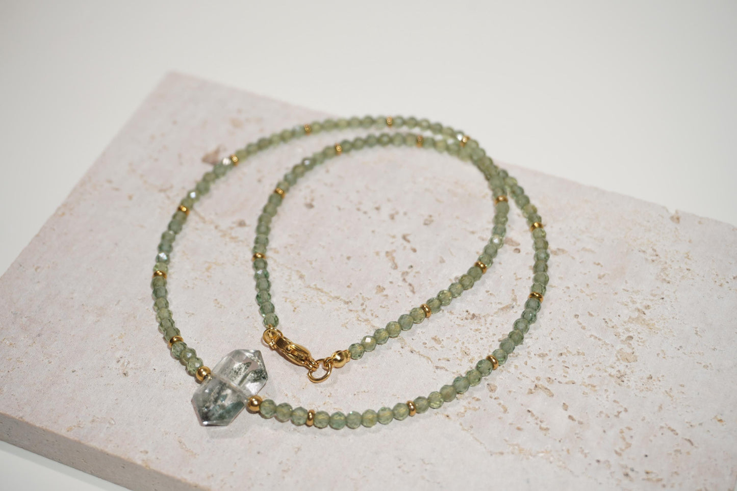 shiny green tone Green Phantom Quartz and green apatite necklace displayed