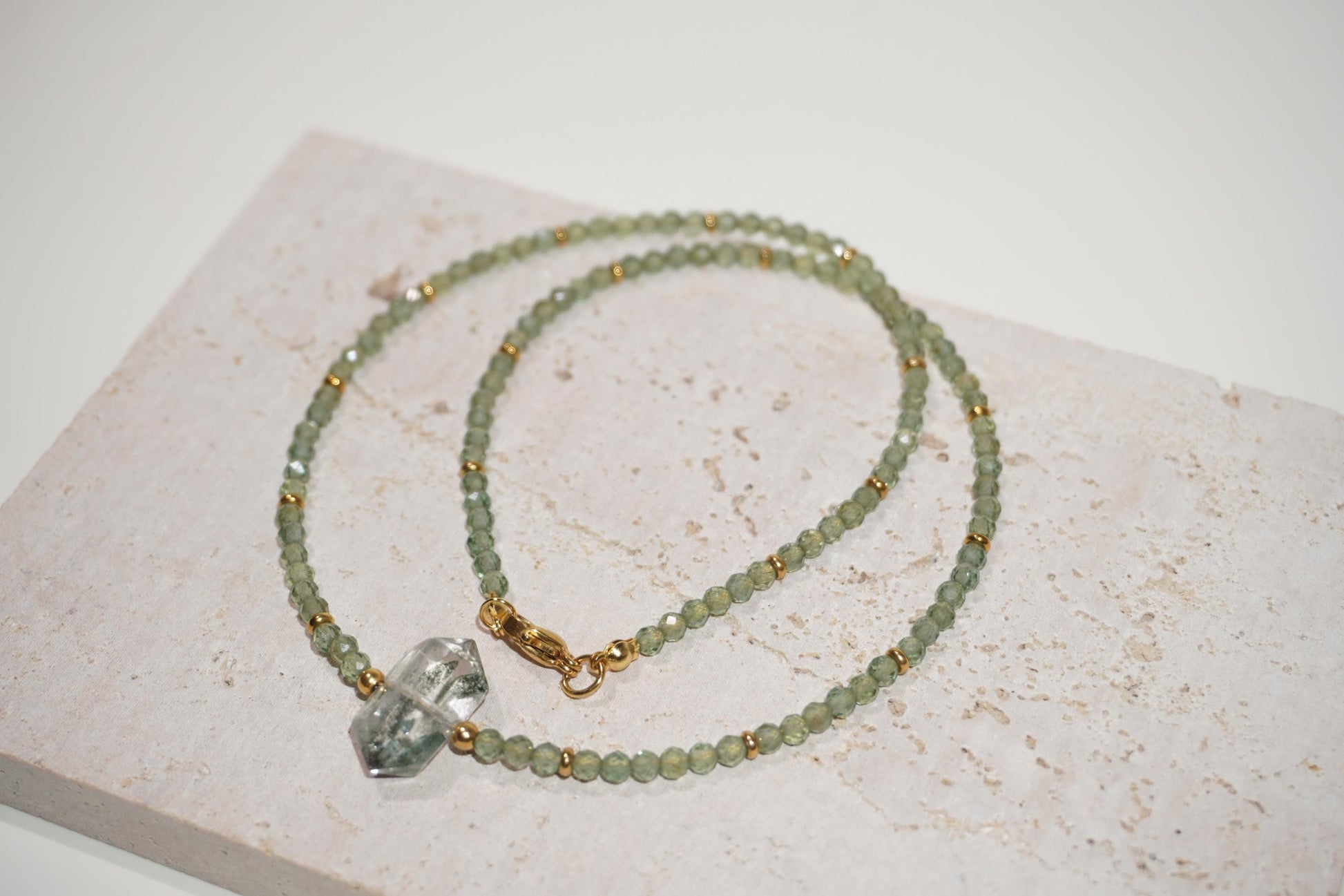 shiny green tone Green Phantom Quartz and green apatite necklace displayed